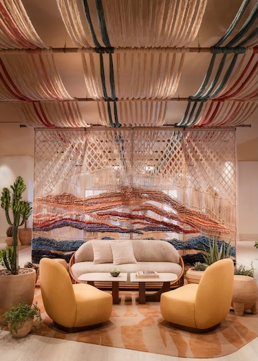Лаунж зона с диваном и текстильной инсталляцией Kimpton Miralina Resort & Villas Opens